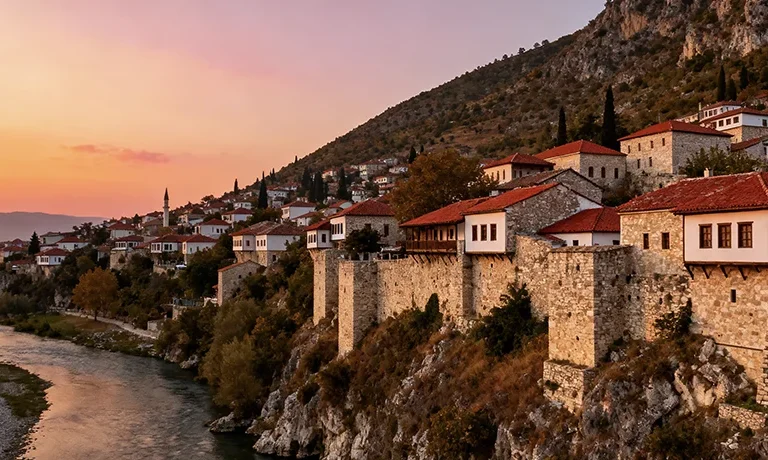 Historic UNESCO city of Berat Albania with Ottoman architecture on hillside at sunset