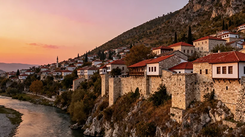Historic UNESCO city of Berat Albania with Ottoman architecture on hillside at sunset