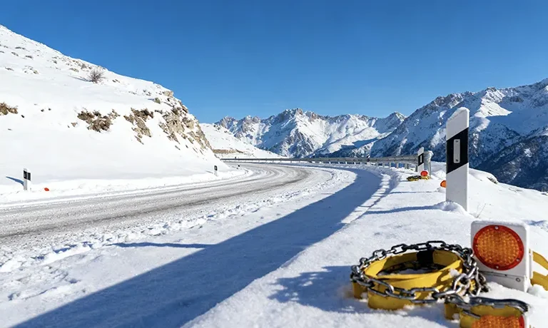 Winter Driving in Albania: Road Conditions, Safety Tips & Mountain Pass Guide (December-February) 2 - Car Rent in Albania Snow covered mountain pass road in Albania with winter driving conditions and safety equipment