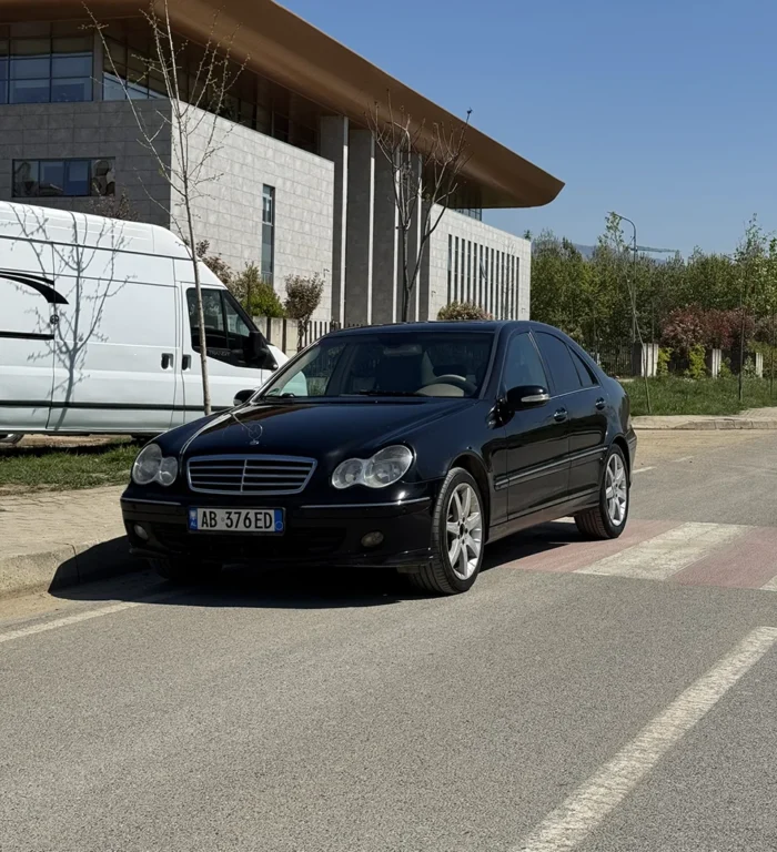 Black Mercedes C-Class 2007 2.2 diesel automatic sedan rear three-quarter view parked on a street in Tirana