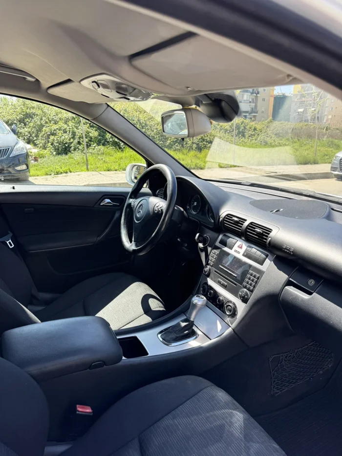 Front passenger seat and dashboard of Mercedes C-Class 2007 1.8 petrol automatic sedan