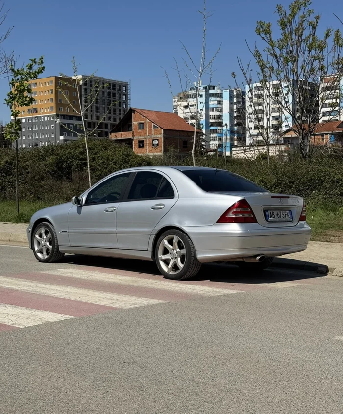 Silver Mercedes C-Class 2007 1.8 petrol automatic sedan rear three-quarter view parked on a street in Tirana