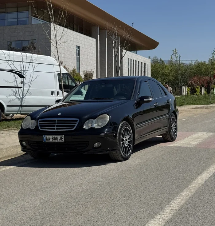 Black Mercedes C-Class 2007 C220 diesel automatic sedan front angle view parked on a street in Albania