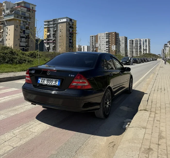 Black Mercedes C-Class 2007 C220 CDI sedan rear three-quarter view parked on a street in Tirana