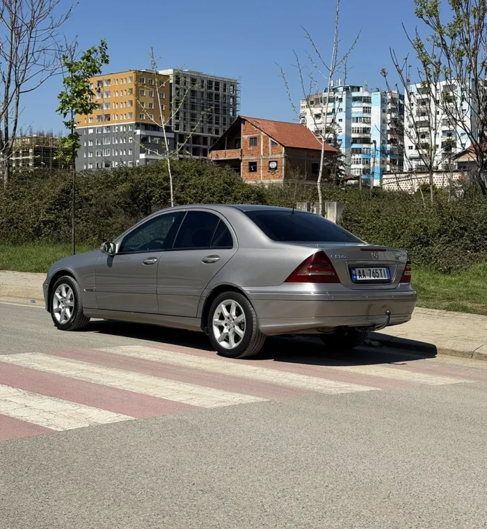 Side view of grey Mercedes C-Class 2007 2.2 diesel automatic sedan parked near apartment buildings in Tirana