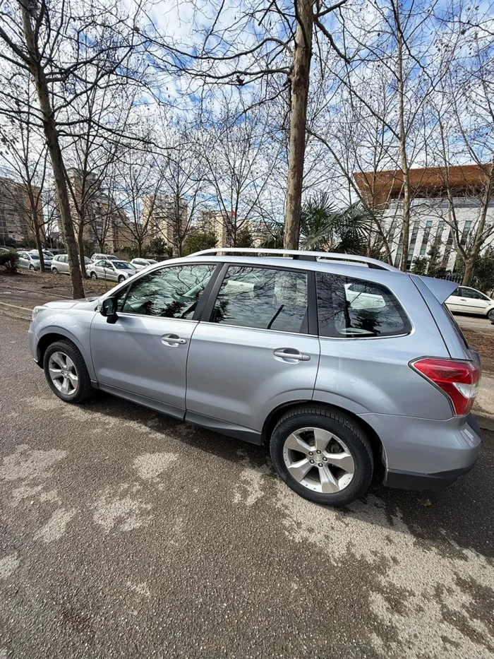 Left side profile of Subaru Forester 2015 silver 4x4 SUV parked in Tirana