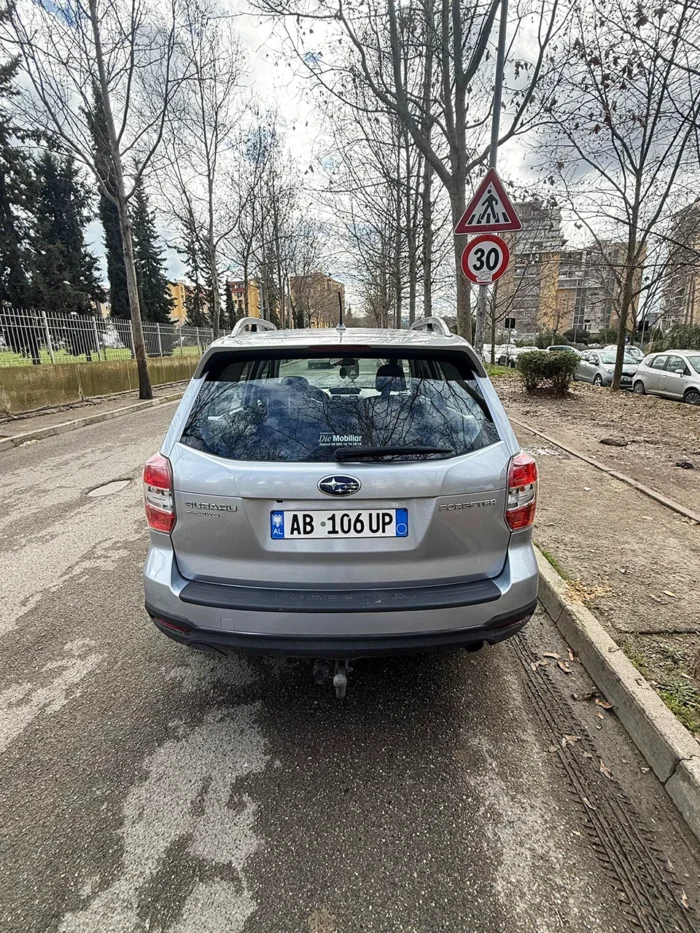 Rear view of Subaru Forester 2015 silver 4x4 SUV with Albanian license plate available for rent in Tirana
