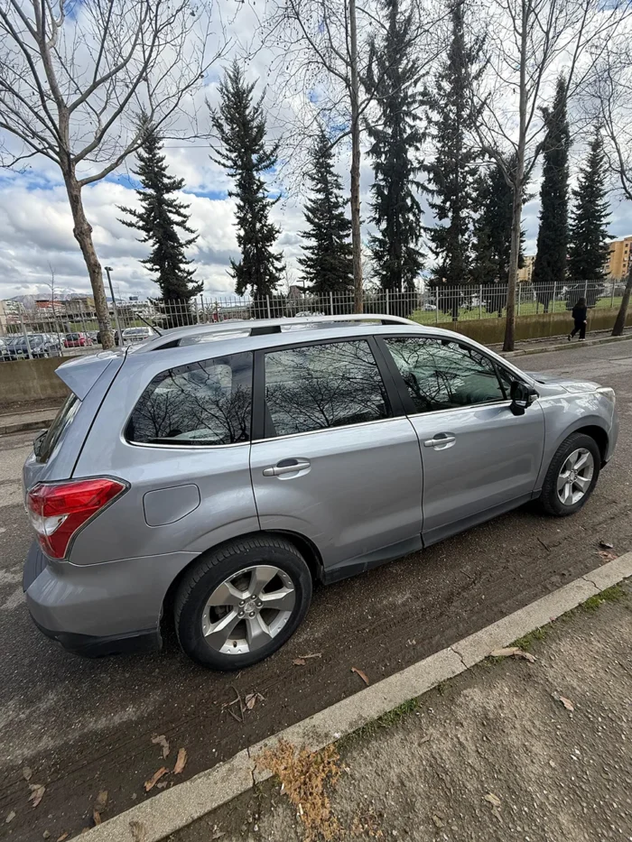 Right side profile of Subaru Forester 2015 silver 4x4 automatic SUV available for rental in Tirana, Albania