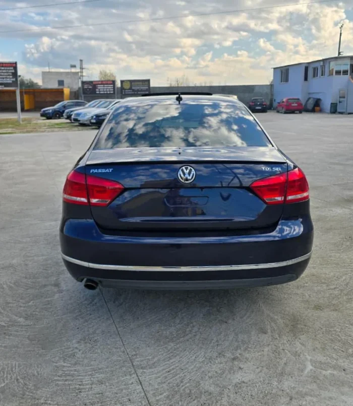 Rear view of VW Passat SEL 2013 2.0 TDI diesel automatic rental car showing TDI SEL badge and large boot