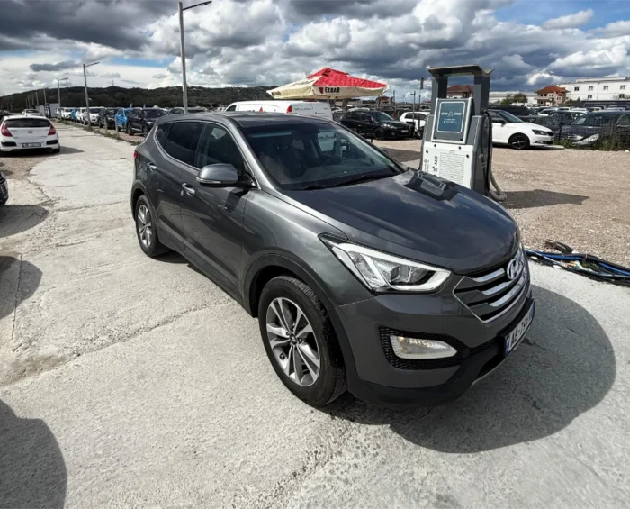 Grey Hyundai Santa Fe 2016 2.0 diesel automatic 4x4 SUV rental car parked near Tirana International Airport Rinas with modern leather interior