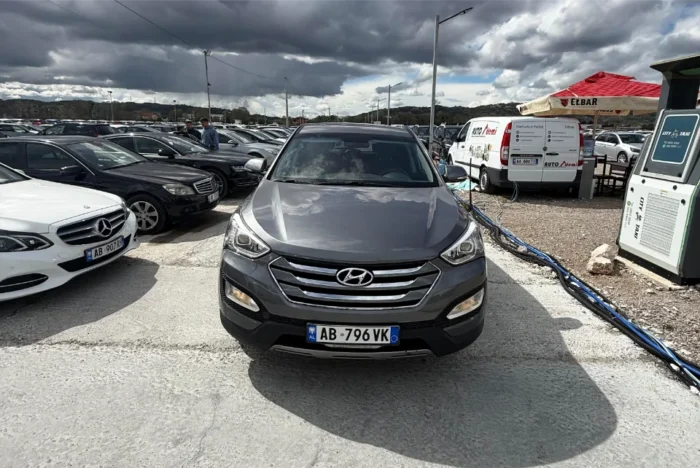 Grey Hyundai Santa Fe 2016 2.0 diesel automatic 4x4 SUV rental car parked near Tirana International Airport Rinas with modern leather interior