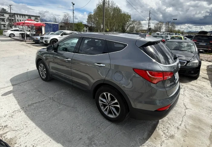Grey Hyundai Santa Fe 2016 2.0 diesel automatic 4x4 SUV rental car parked near Tirana International Airport Rinas with modern leather interior
