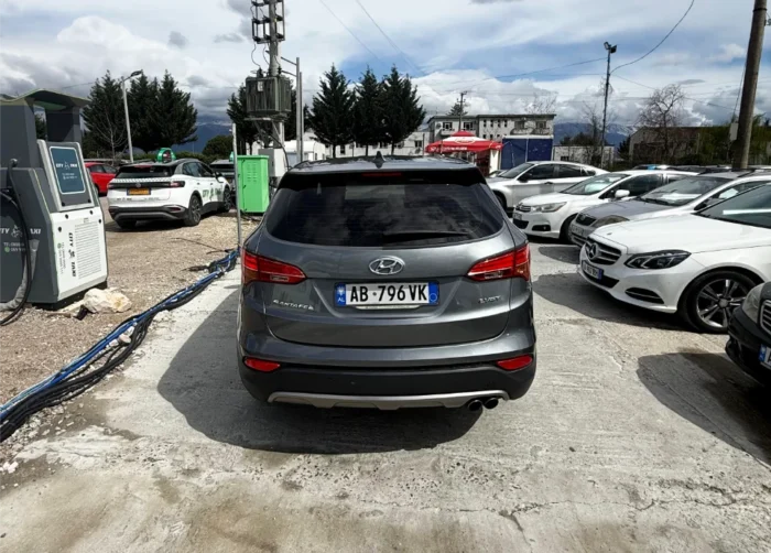 Grey Hyundai Santa Fe 2016 2.0 diesel automatic 4x4 SUV rental car parked near Tirana International Airport Rinas with modern leather interior