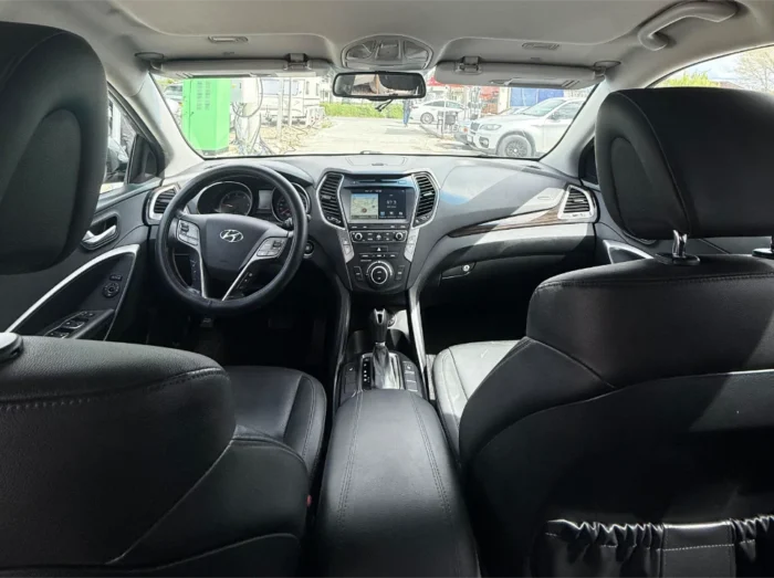 Grey Hyundai Santa Fe 2016 2.0 diesel automatic 4x4 SUV rental car parked near Tirana International Airport Rinas with modern leather interior