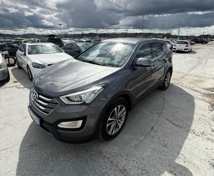 Grey Hyundai Santa Fe 2016 2.0 diesel automatic 4x4 SUV rental car parked near Tirana International Airport Rinas with modern leather interior
