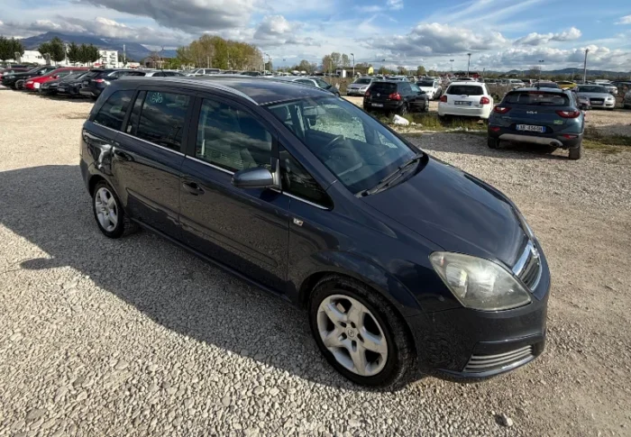 Dark Opel Zafira 2008 2.0 diesel manual 7 seater MPV rental car parked near Tirana International Airport Rinas with flexible three row seating