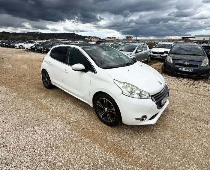 White Peugeot 208 2016 1.6 diesel automatic hatchback with full panoramic glass roof parked on the rental car lot near Tirana International Airport Rinas