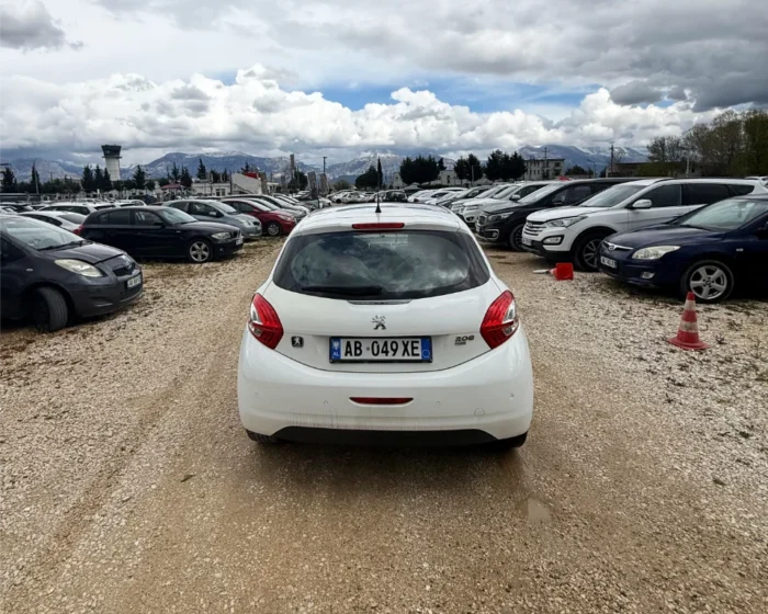 White Peugeot 208 2016 1.6 diesel automatic hatchback with full panoramic glass roof parked on the rental car lot near Tirana International Airport Rinas