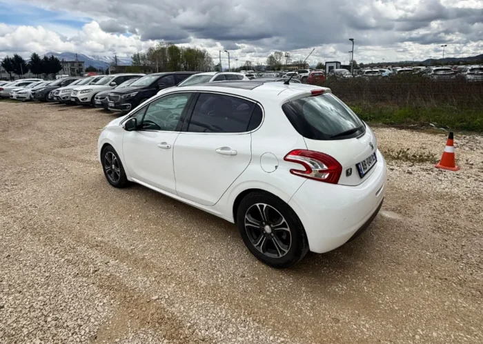 White Peugeot 208 2016 1.6 diesel automatic hatchback with full panoramic glass roof parked on the rental car lot near Tirana International Airport Rinas