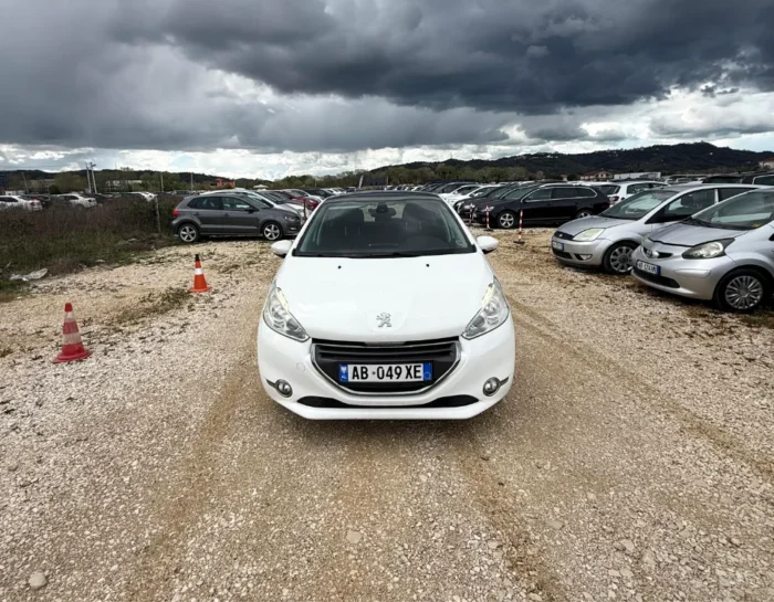 White Peugeot 208 2016 1.6 diesel automatic hatchback with full panoramic glass roof parked on the rental car lot near Tirana International Airport Rinas