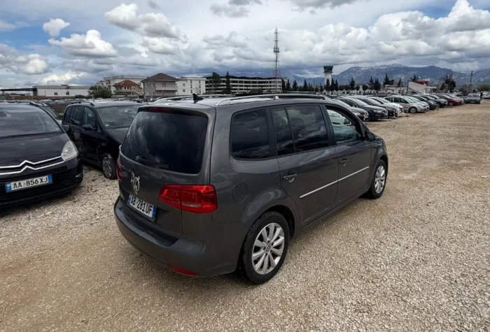 Rear three-quarter view of gray VW Touran 2013 7-seater 2.0 TDI diesel automatic rental MPV in Albania