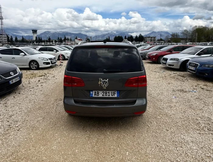 Rear three-quarter view of gray VW Touran 2013 7-seater 2.0 TDI diesel automatic rental MPV in Albania