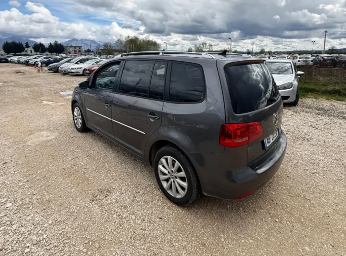 Rear angle view of VW Touran 2013 7-seater 2.0 TDI diesel automatic rental MPV parked in Albania