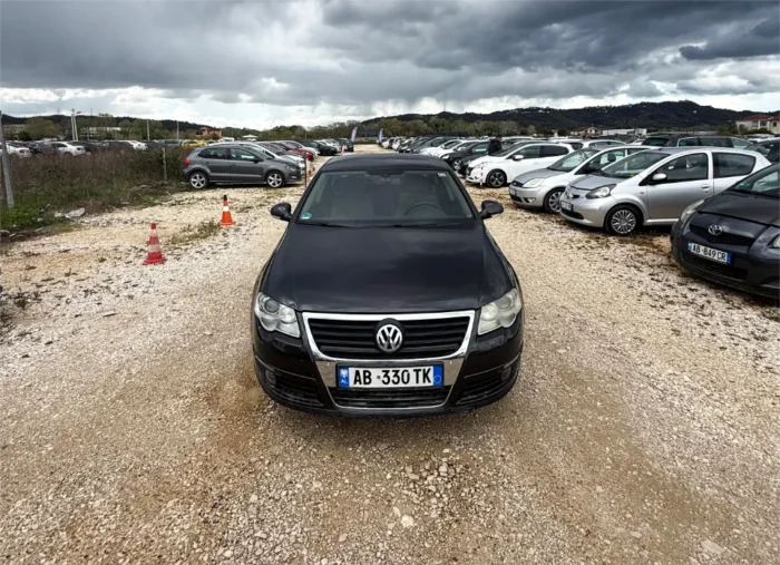 Black Volkswagen Passat 2010 2.0 TDI diesel automatic sedan rental car parked near Tirana International Airport Rinas with spacious, air‑conditioned interior