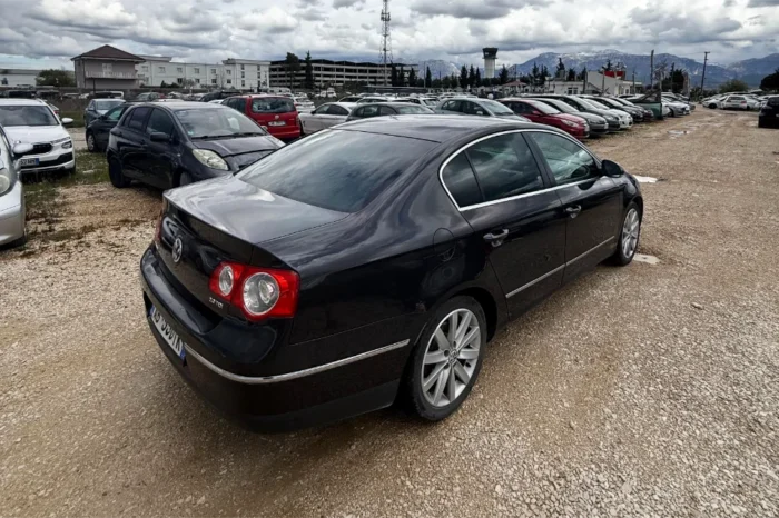 Black Volkswagen Passat 2010 2.0 TDI diesel automatic sedan rental car parked near Tirana International Airport Rinas with spacious, air‑conditioned interior