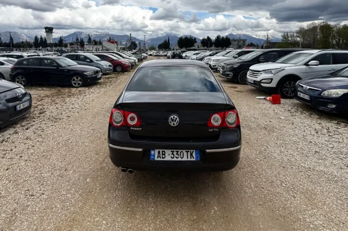 Black Volkswagen Passat 2010 2.0 TDI diesel automatic sedan rental car parked near Tirana International Airport Rinas with spacious, air‑conditioned interior