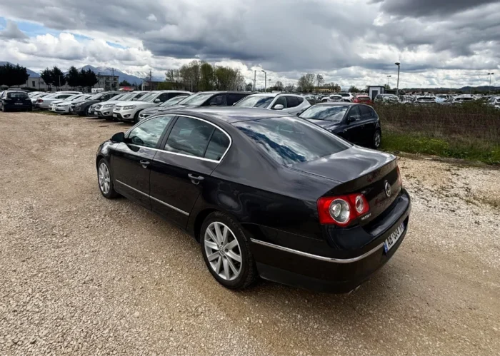 Black Volkswagen Passat 2010 2.0 TDI diesel automatic sedan rental car parked near Tirana International Airport Rinas with spacious, air‑conditioned interior