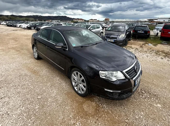 Black Volkswagen Passat 2010 2.0 TDI diesel automatic sedan rental car parked near Tirana International Airport Rinas with spacious, air‑conditioned interior