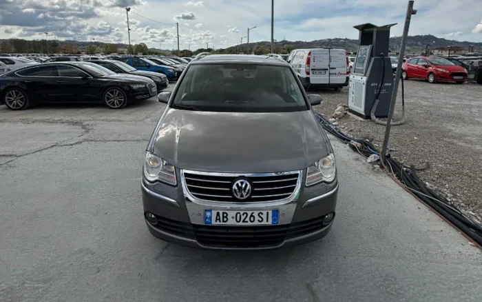 Grey Volkswagen Touran 2008 1.6 petrol automatic compact MPV rental car parked near Tirana International Airport Rinas with leather interior