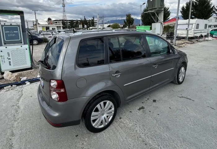Grey Volkswagen Touran 2008 1.6 petrol automatic compact MPV rental car parked near Tirana International Airport Rinas with leather interior