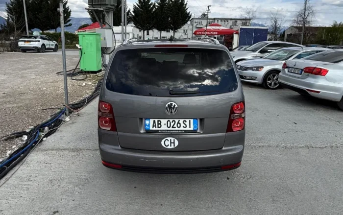 Grey Volkswagen Touran 2008 1.6 petrol automatic compact MPV rental car parked near Tirana International Airport Rinas with leather interior