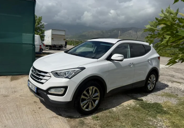 White Hyundai Santa Fe 2015 2.2 diesel automatic 7 seater SUV parked near Tirana, available for car rental in Albania with TiRental