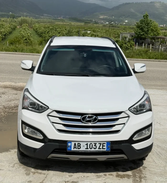 White Hyundai Santa Fe 2015 2.2 diesel automatic 7 seater SUV parked near Tirana, available for car rental in Albania with TiRental