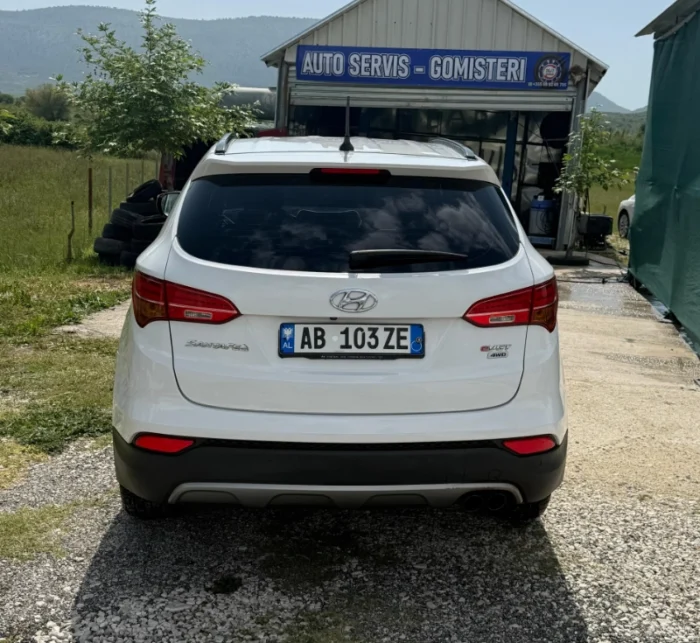 White Hyundai Santa Fe 2015 2.2 diesel automatic 7 seater SUV parked near Tirana, available for car rental in Albania with TiRental