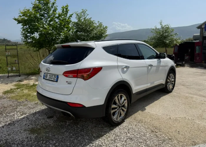 White Hyundai Santa Fe 2015 2.2 diesel automatic 7 seater SUV parked near Tirana, available for car rental in Albania with TiRental