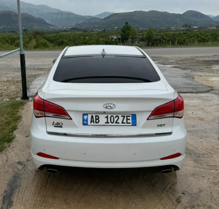 White Hyundai i40 2012 1.7 diesel automatic mid‑size sedan parked in the Albanian countryside, available for rent from Tirana and Tirana Airport Rinas