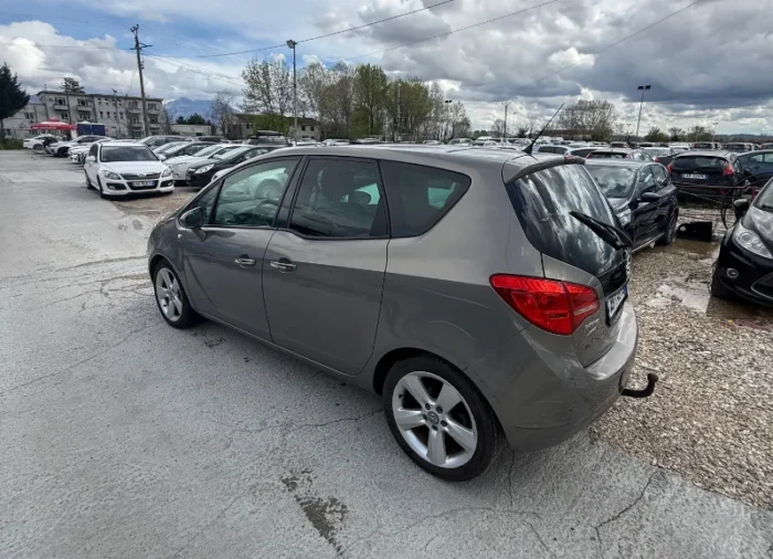 Grey Opel Meriva 2012 2.0 diesel manual compact MPV with panoramic sunroof and dark interior parked near Tirana International Airport Rinas