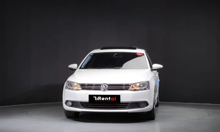 White Volkswagen Jetta 2014 2.0 TDI diesel automatic sedan with sunroof and TiRental branding, available for car rental in Tirana Albania