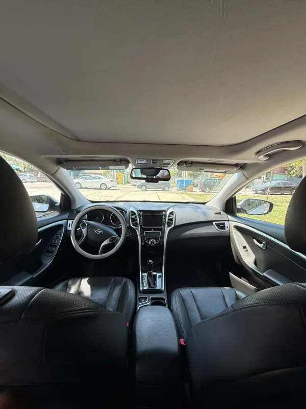 White Hyundai i30 2014 1.6 CRDi diesel automatic hatchback with full panoramic roof parked in Tirana, available for car rental in Albania with TiRental
