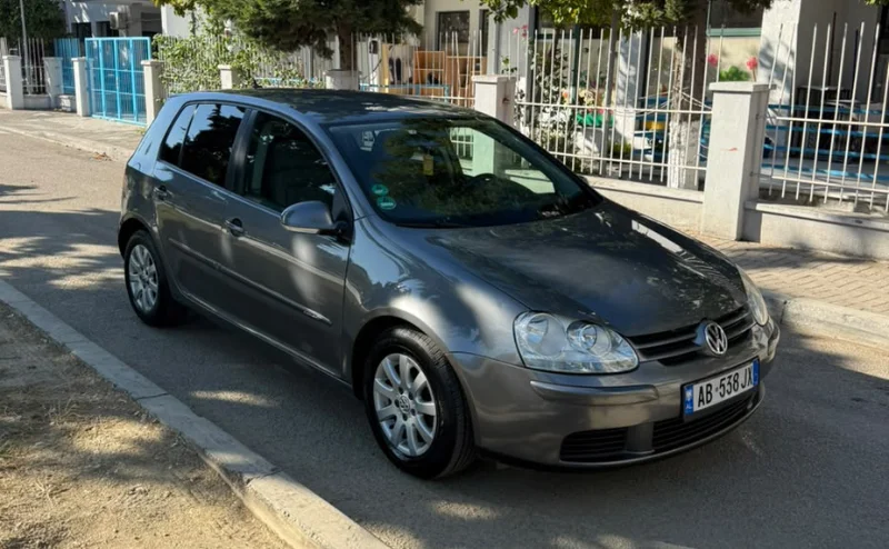 Volkswagen Golf V 2007 1.9 TDI Automatic Diesel – Compact Hatchback Rental in Albania 33 - Car Rent in Albania Grey Volkswagen Golf V 2007 1.9 TDI automatic diesel five‑door hatchback parked in Tirana, available for car rental in Albania with TiRental