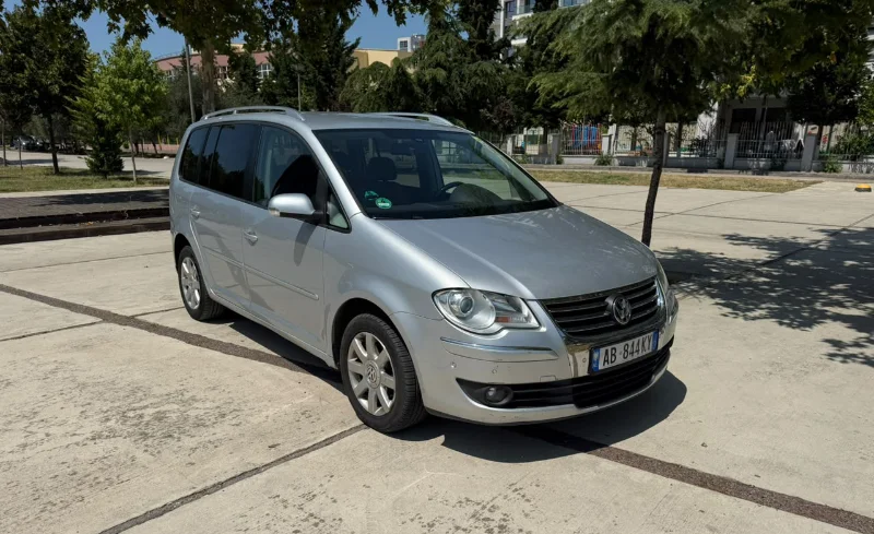 Volkswagen Touran 2.0 TDI Automatic 2008 - 7 Seater Family Van Rental in Albania 43 - Car Rent in Albania Silver Volkswagen Touran 2.0 TDI automatic 2008 seven‑seater MPV parked in Tirana, available for family van rental in Albania with TiRental