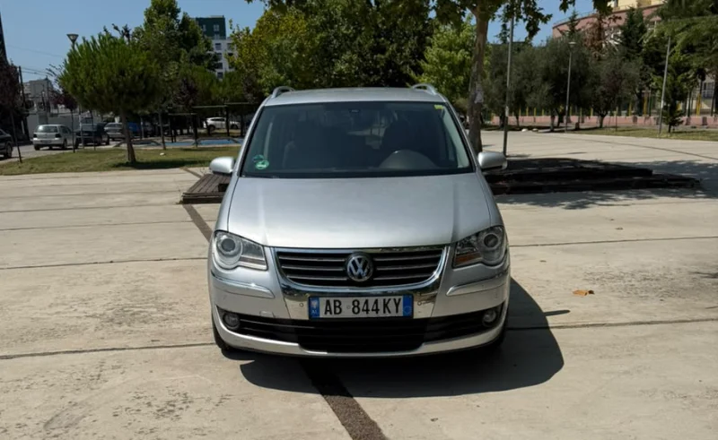 Volkswagen Touran 2.0 TDI Automatic 2008 - 7 Seater Family Van Rental in Albania 45 - Car Rent in Albania Silver Volkswagen Touran 2.0 TDI automatic 2008 seven‑seater MPV parked in Tirana, available for family van rental in Albania with TiRental