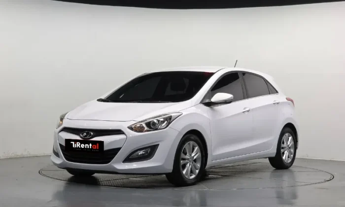 White Hyundai i30 2013 1.6 CRDi diesel automatic five‑door hatchback parked in Tirana, offered as an eco city hatchback rental in Albania by TiRental