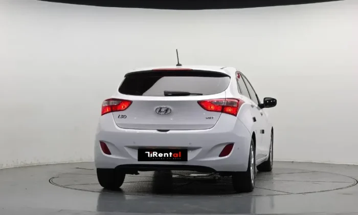 White Hyundai i30 2013 1.6 CRDi diesel automatic five‑door hatchback parked in Tirana, offered as an eco city hatchback rental in Albania by TiRental