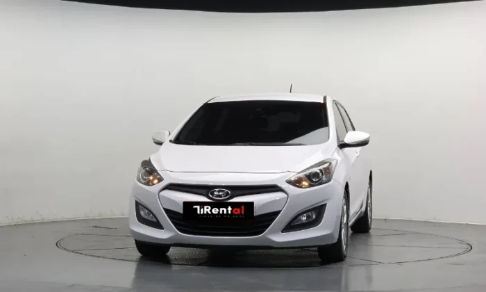 White Hyundai i30 2013 1.6 CRDi diesel automatic five‑door hatchback parked in Tirana, offered as an eco city hatchback rental in Albania by TiRental