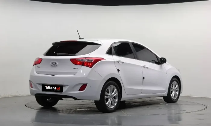 White Hyundai i30 2013 1.6 CRDi diesel automatic five‑door hatchback parked in Tirana, offered as an eco city hatchback rental in Albania by TiRental